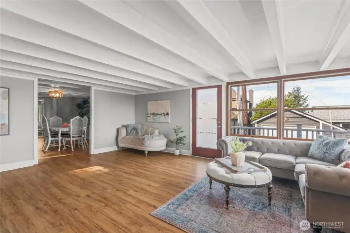 The spacious living room opens into the central dining room.