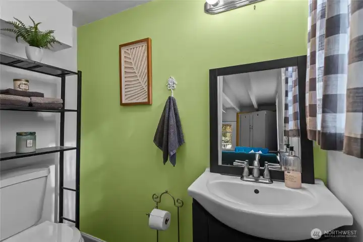 The main floor half bath waits at the back of the front sitting room.