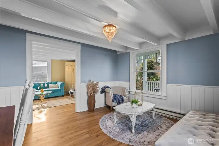 A second front room overlooks the covered porch. Wainscot and beamed ceilings keep the turn-of-the-century origins of this cottage present today.