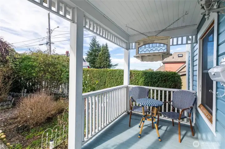 The covered front porch is complete with a swing and space for a little sitting area from which one can enjoy the garden and a cup of tea.