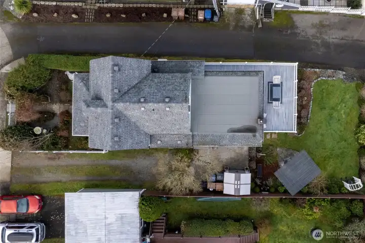 This 1,520 sq ft home is set on a 4,170 sq ft lot with a driveway for parking, a fenced front garden, a wraparound deck, and a back lawn.