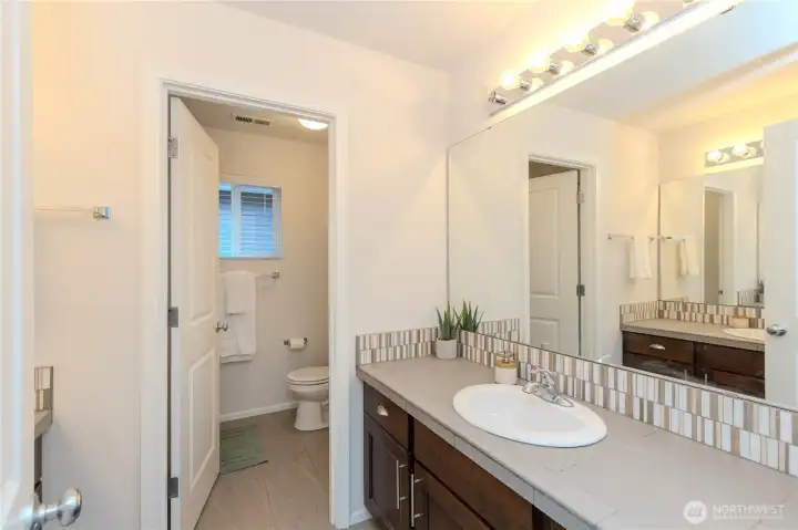 Main upstairs bathroom with 2 sink/vanity on each wall w/separate bath/toilet.