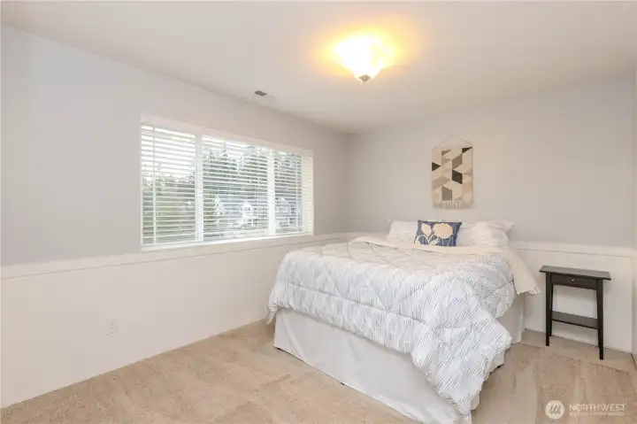 2nd bedroom w/chair rail molding.