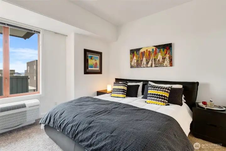 Spacious bedroom retreat with plush carpeting (2024) and peaceful outlook.