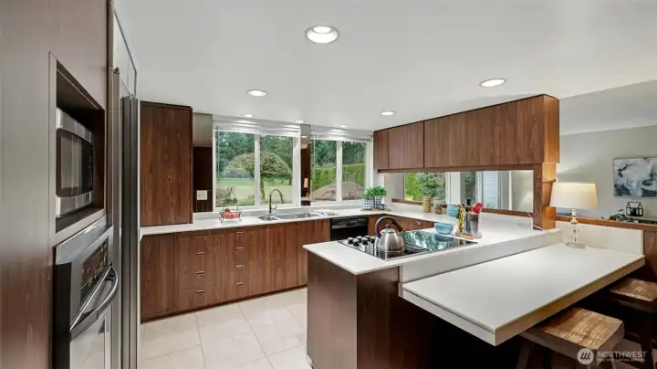 A spacious kitchen featuring abundant cabinetry, generous counter space, and a convenient breakfast bar perfect for casual dining.