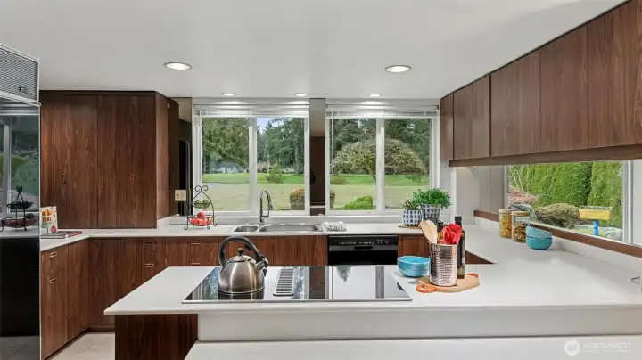 These large windows bring the outdoors in, creating a bright and welcoming kitchen with plenty of room to cook and gather.