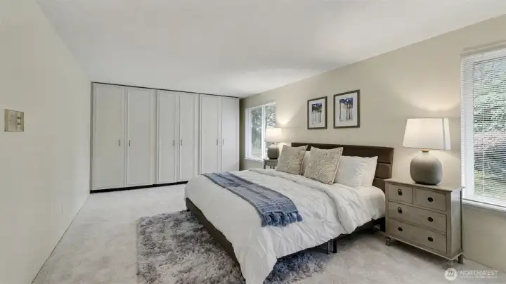 Spacious and inviting, this luxurious primary suite combines comfort, style, and impressive storage.