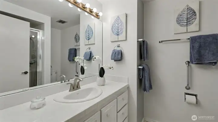 The primary bath features a spacious vanity and convenient tub/shower combo, creating a comfortable daily retreat.
