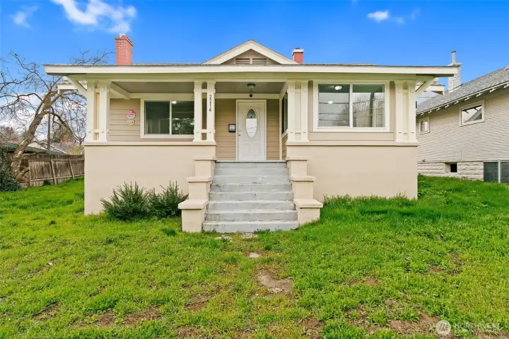 Front of home with steps to the inviting covered porch.