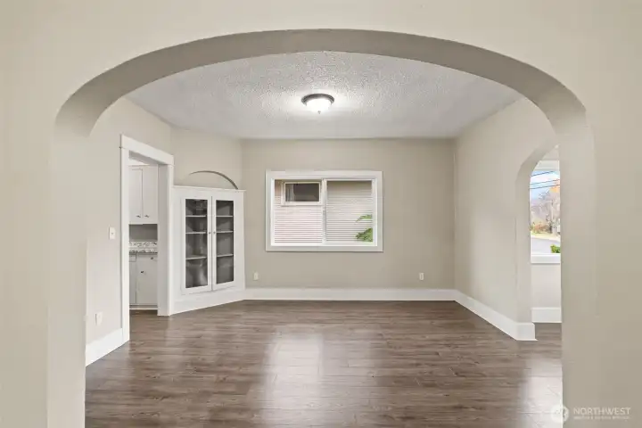 Flexible dining or sitting area off the kitchen with arched entryway.