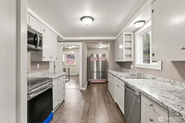 Inviting kitchen with white cabinetry and ample natural light.