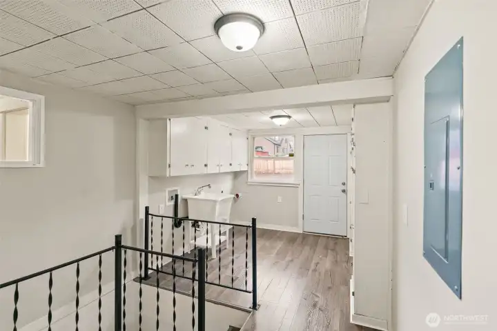 Staircase leading to lower level near mudroom.