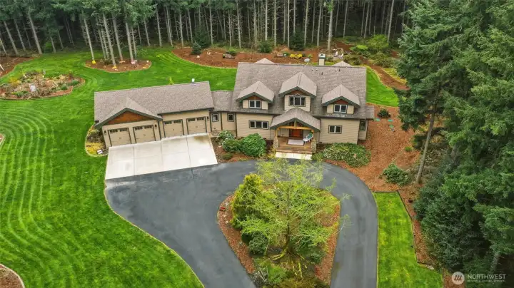 Teardrop driveway and lush grass are just the beginning of all you'll enjoy and appreciate here, starting with the 4-car garage with bonus space!
