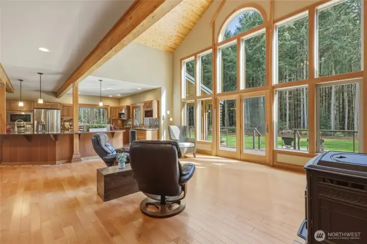 The expanse of windows combined with natural beauty create a warmth and peacefulness unmatched. Living room and kitchen blend seamlessly in this stunning space.