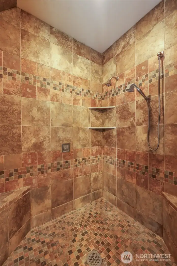 Walk-in-shower has multiple heads to help you gear up or wind down... including some in the ceiling, just outside of photo, top left!