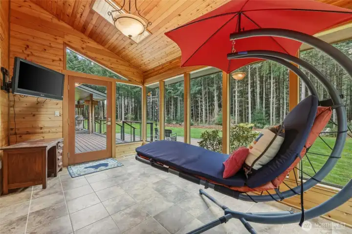 Off the primary and the back deck you can access this fantastic solarium, complete with skylights and the beautiful tongue-and-groove distinctive look of Lindal homes... enjoy these peaceful views during any season!