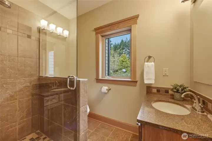 Just off the mudroom is this terrific 3/4 bath with frameless glass shower; wonderful for cleaning off after gardening or as an additional option for guests.