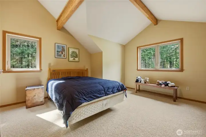 Bedroom #3 also offers the lovely artichitecture and beams, as well as multiple windows.