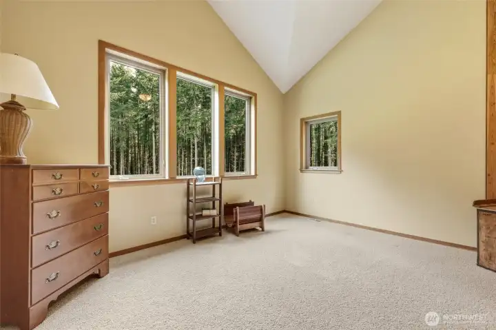Bedroom #4 features more open ceilings, and another wall of windows to the natural oasis in the backyard, as well as a walk-in-closet.