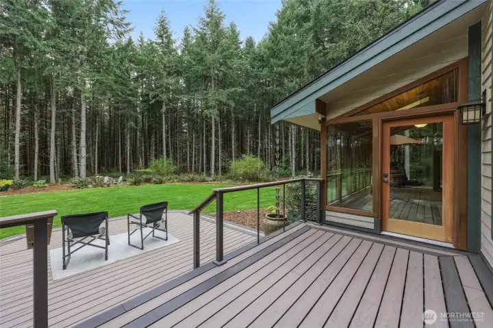 Cable railings offer unterrupted views on the upper level.  Door to solarium seen here, for another way to enjoy this yard all year.