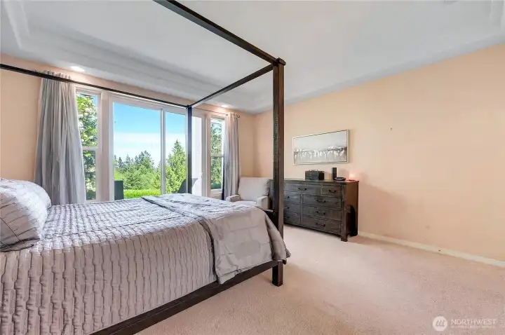 Primary bedroom with slider door to back deck and a view
