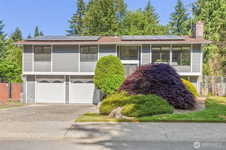 robust newer solar panel system with a backup generator, a newer Tesla EV charger, and a relaxing covered outdoor hot tub.
