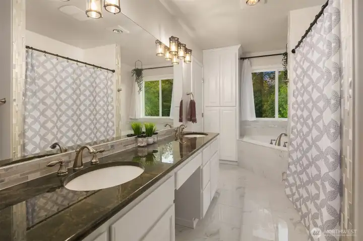 Relax and unwind in your own personal spa. The primary en-suite bath features polished granite counters and a spacious step-in shower with dual showerheads. Relax and unwind in your own personal spa. The primary en-suite bath features polished granite counters and a spacious step-in shower with dual showerheads.