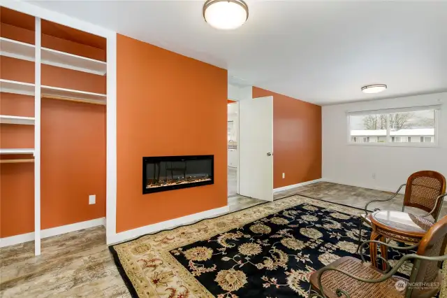 Large bonus room w/ laminate wood floors & electric fireplace--provides heat too!