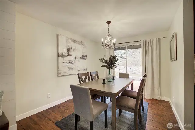 The dining room offers a view of the patio and backyard beyond.