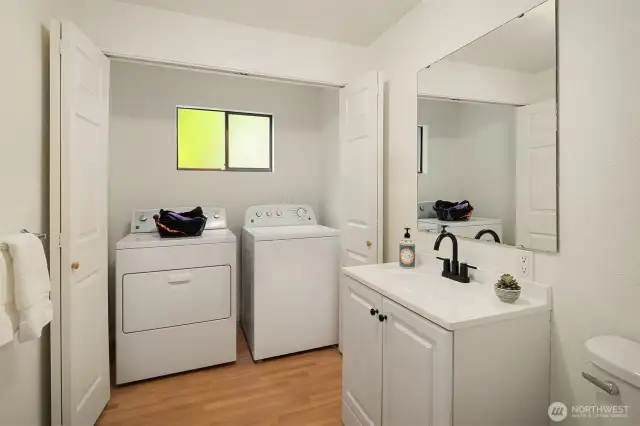 Large laundry room combined with 1/2 bath.