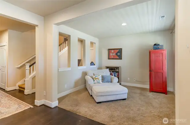 Open den area on main level offers a place for a home office or cozy reading area.