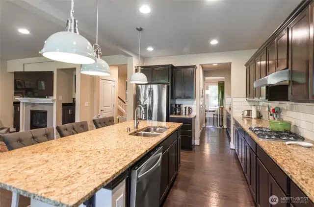 Beautiful quartz counter tops.  notice how much space there is to cook!  Decorative overhead lighting.