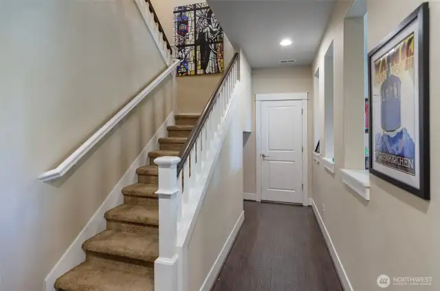 Hallway leads to the tandem 4 car garage.  Stairs to upper level.