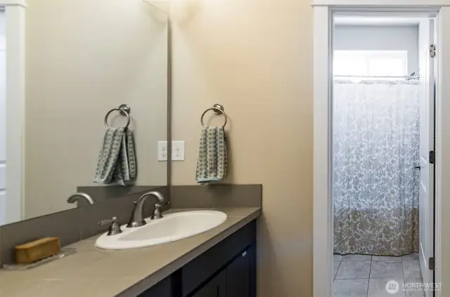 Hall full bath has separate shower/tub and toilet area.