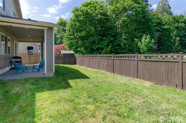 Room for play and gardening with this sunny back yard.