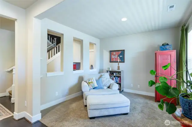 Open den area on main level offers a great place for a home office or cozy reading area.