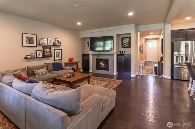 View showing TV area.  Notice the built-in cabinetry, gas fireplace and mantle.