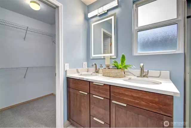 New vanity with countertop and walk in closet near by.