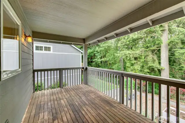 Upper covered deck faces greenbelt.