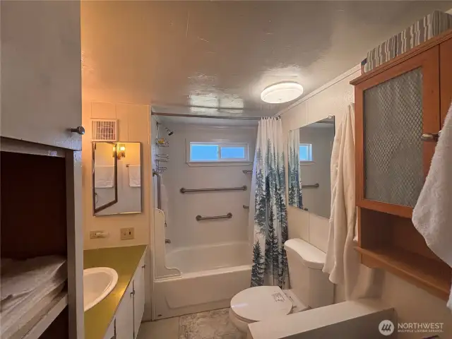 Bathroom with nice size bathtub.