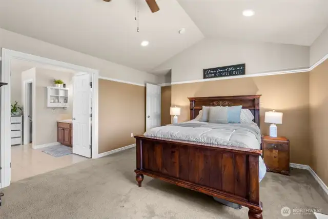 Roomy primary bedroom with pitched ceiling