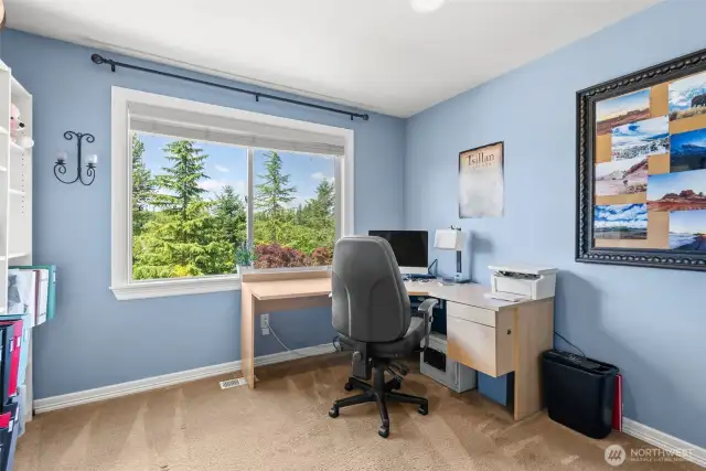 Home office with french doors and a big window that overlooks the backyard