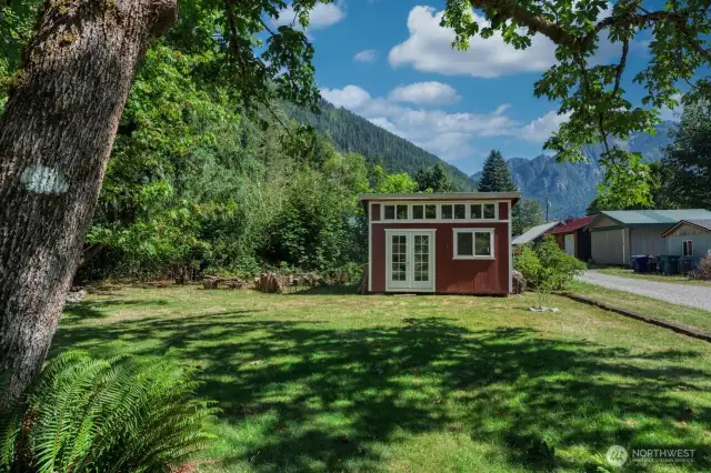 A detached light-filled studio offers space for art, projects, or your next big idea.