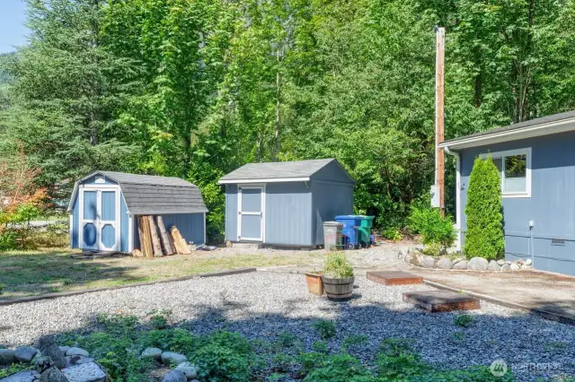 Two outbuildings provide space for tools, toys or equipment.