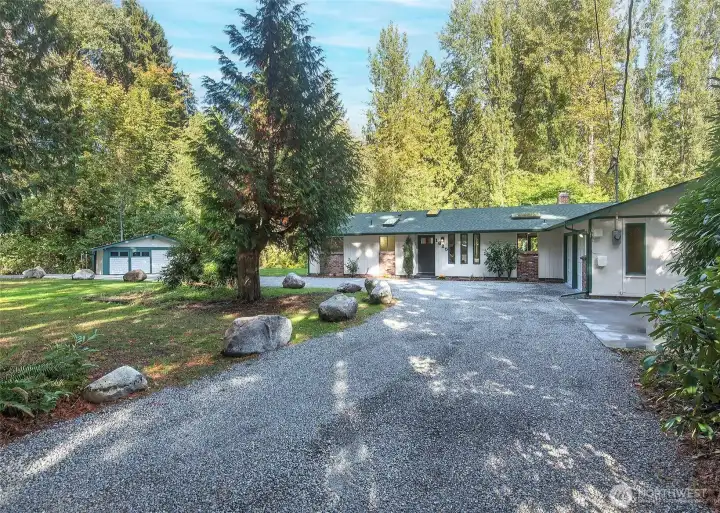 Home and shed with a  wrap around drive.