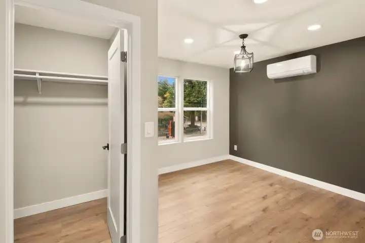 Upper level primary suite with mini-split heating/cooling system & 8 ft ceilings.