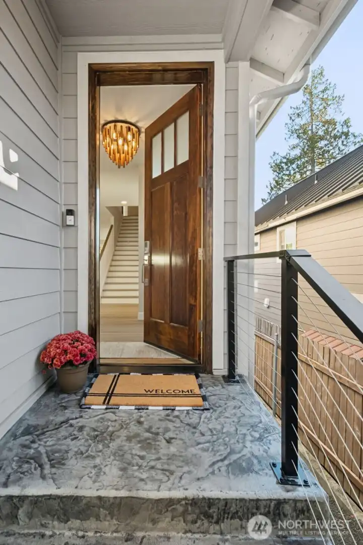 From the moment you arrive, the home’s craftsmanship is evident in every detail. The stamped concrete driveway adds a touch of sophistication and texture, setting the stage for what’s inside. A thoughtfully designed covered entry creates a warm, inviting welcome for guests and a grand first impression for homeowners.