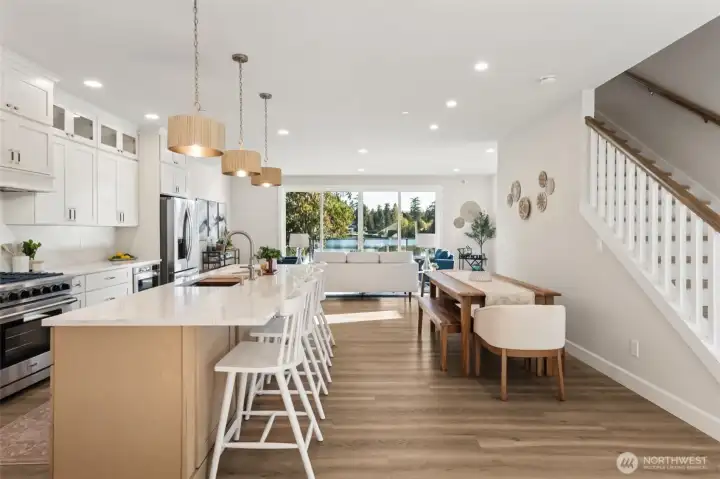 The expansive great room creates a seamless flow between living, dining, and kitchen spaces. Designed for both entertaining and relaxing, it’s a gathering place that feels as inviting as it is impressive.