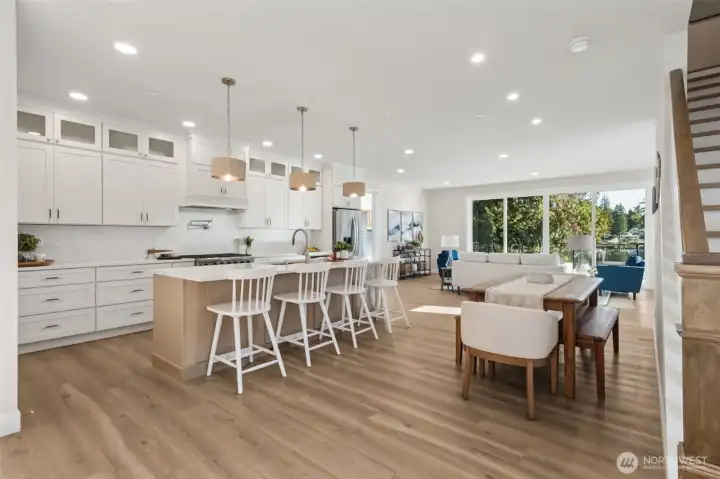 This stunning kitchen is a chef’s dream, equipped with premium appliances, quartz countertops, and soft-close custom cabinetry. Every detail is designed for functionality and beauty, making it the heart of the home.