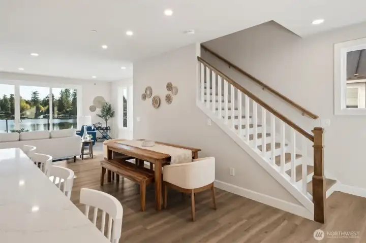 The open-concept great room and dining area are designed for connection, comfort, and breathtaking views. Expansive windows frame Lake Lucerne, filling the space with natural light and a serene sense of openness.